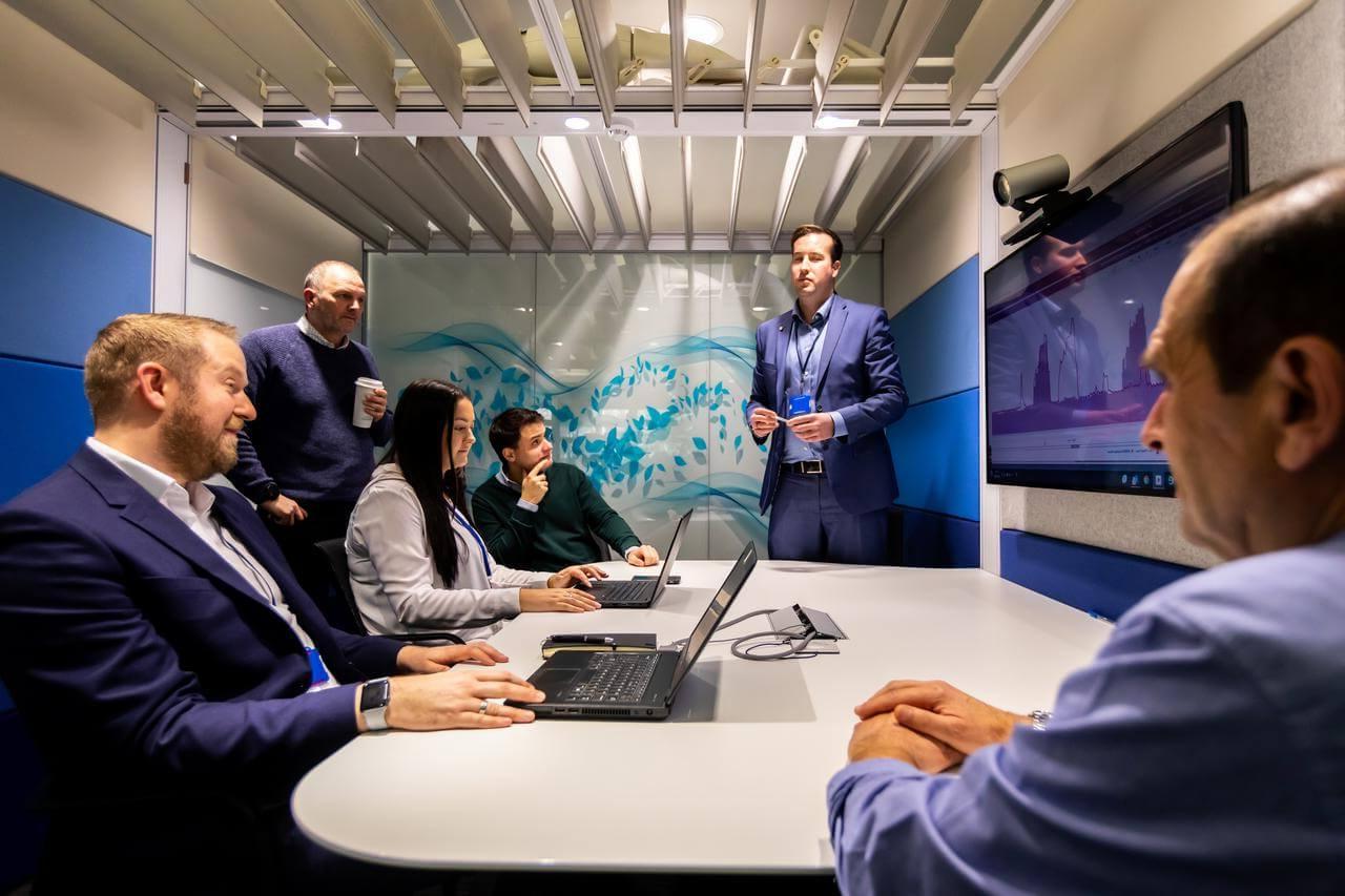 Group of men and women in an office meeting